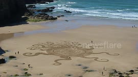 porth near newquay, the famous sand artist on the beach