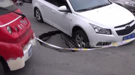 Car trapped in sink hole