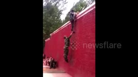 Trio climb up four meter high wall