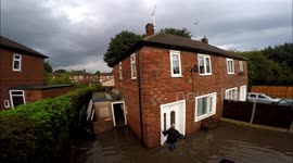 Drone captures neighbours' efforts to clear flood water