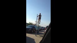 Man cycles down Detroit street on tall bike