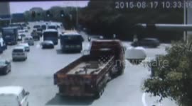 Two men on scooter survive run over by truck