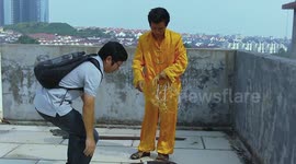 Man inflates a tyre using his ears