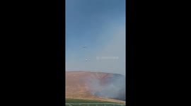Airplane dumping retardant on wild fire
