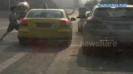 Man punches taxi driver repeatedly through window