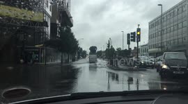 Flooded London street amid heavy rain