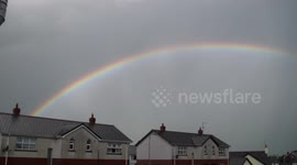 Rainbow Drawing Across The Sky Like  A Curtain