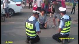 Traffic cops and a mother kneel down to each other