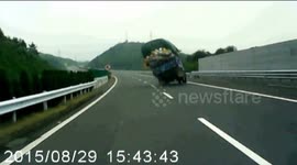 Overloaded truck turns over on highway