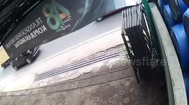 Motorcycle rider has lucky escape after being knocked over by truck and narrowly missing the wheels