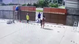 Sliding metal gate falls on worker as colleagues close garage