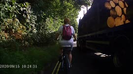 HGV close passing a woman riding a bike on the A57 Derbyshire