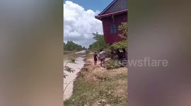 Villagers carry entire house across river after in Cambodia