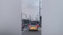 Skillful workers balance on electric cables