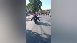 Motorcyclist carries shark on the back of bike
