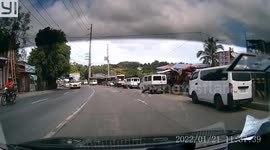 Biker narrowly avoids being crushed to death after sliding towards oncoming truck
