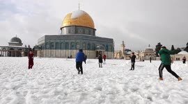 Children play in snow as blizzards hits Jerusalem covering buildings and closing roads