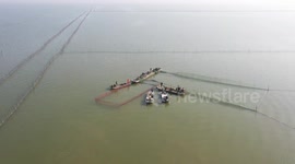 Aerial footage of farmers fishing in Suqian, Jiangsu, China