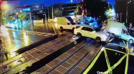 Motorbike rider smashes through level crossing barrier
