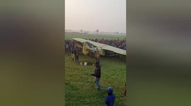 Crowds of villagers gather when Indian military aircraft goes down