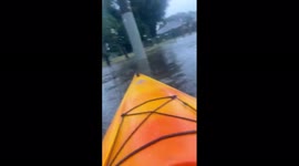 Melbourne resident kayaks through streets submerged by floodwater
