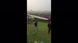 Watch -Group of villagers lift out a crashed Aircraft on their shoulder out of farm land