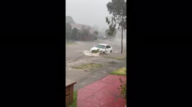 Watch as a residential road is turned into a river by flash flooding after huge storm strikes Melbourne, Australia