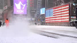 New Yorkers battle wind-driven snow as crews work to clear Manhattan streets and sidewalks with plows and shovels