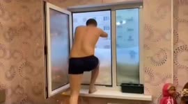 Daredevil dives into snowdrift right outside his window