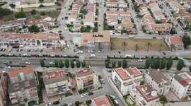 Nice hyperlapse in urbanization, with several cars, roundabout, houses and trees
