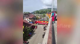 Passenger bus roof ripped off after driving under low flyover in Indonesia