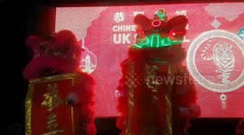 Visitors enjoy lion dancing and night market in London's Chinatown on Chinese New Year Eve