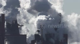 Cold weather in Ontario Canada makes for dramatic visual scenes of air pollution and carbon dioxide greenhouse gas emissions from smokestacks in heavy industry