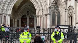 Police guard the High Court entrance where Insulate Britain protesters glued themselves to the steps
