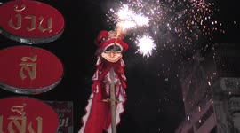 Lion dancer atop large pole unveils 'Happy New Year' banner to crowds in Thailand