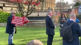 Protester confronts UK minister Michael Gove during live interview