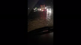 Motorway flooded multiple cars and vans driving through the river