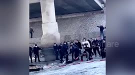 Police and locals form human chain to rescue girls from frozen river in China
