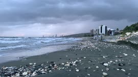 Storm on the sea. View of the stormy sea from the shore. Cloudy weather at sea.