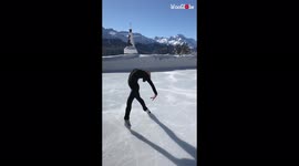 Figure skater performs amazing routine on ice rink backdropped by Swiss mountains