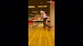Mind-boggling footage of man scoring a strike by throwing disc at bowling pins