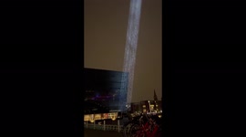 Rain drifts through the light during Copenhagen Light Festival in Denmark