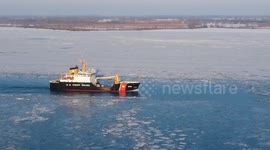 Drone footage of coast guard boat going thru ice on the detroit river