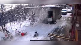Heaps of snow slide off house roof in China and land on children below