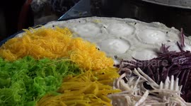 Thai street food vendor cooks delicious coconut rice pancakes