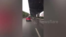 Car carrier trailer hits overhead signboard in Thailand