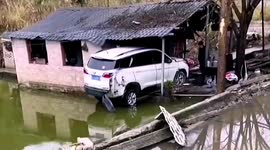 Out of control car flies over pond and smashes into house in China