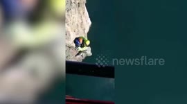 Italian firemen rescue rock climbers trapped on high cliff face