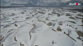 Drone footage shows sand dunes frosted with snow in Pakistani desert