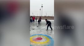Chinese family uses kettle and mop to play curling at their own DIY Winter Olympics